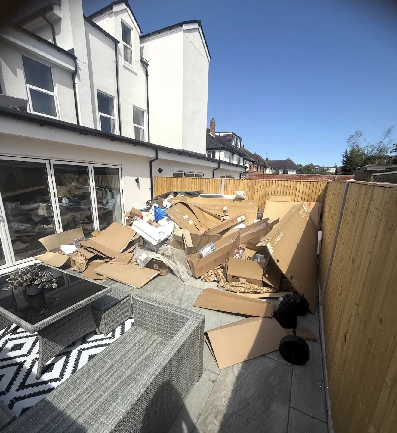 Waste and cardboard before patio clearance